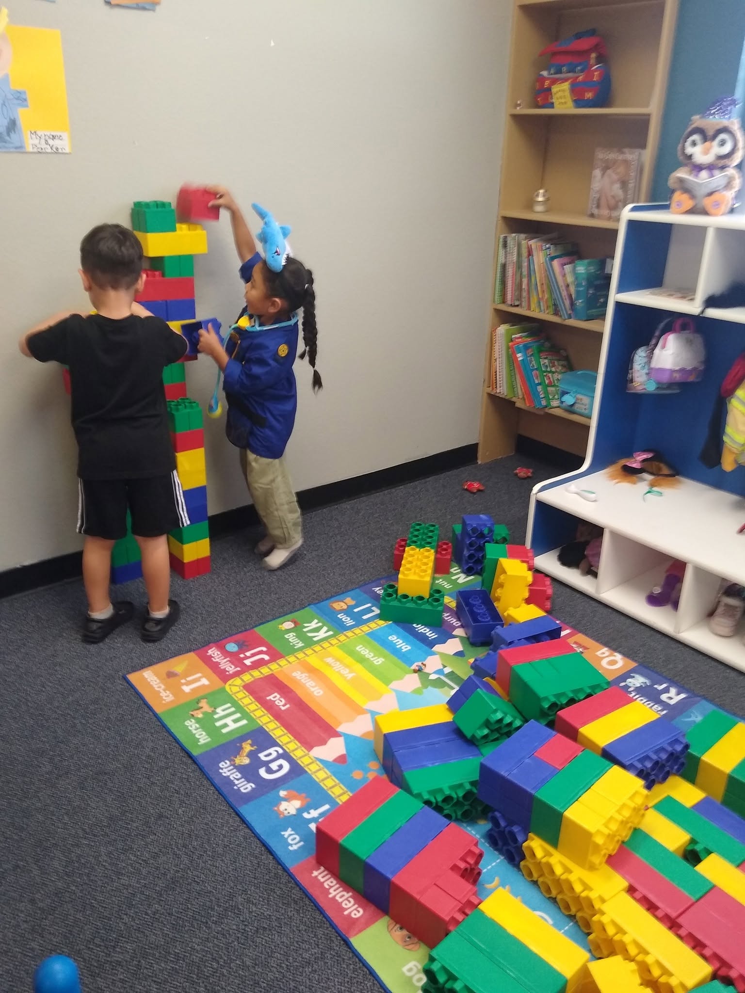 Two children stacking blocks in a Little Love's classroom