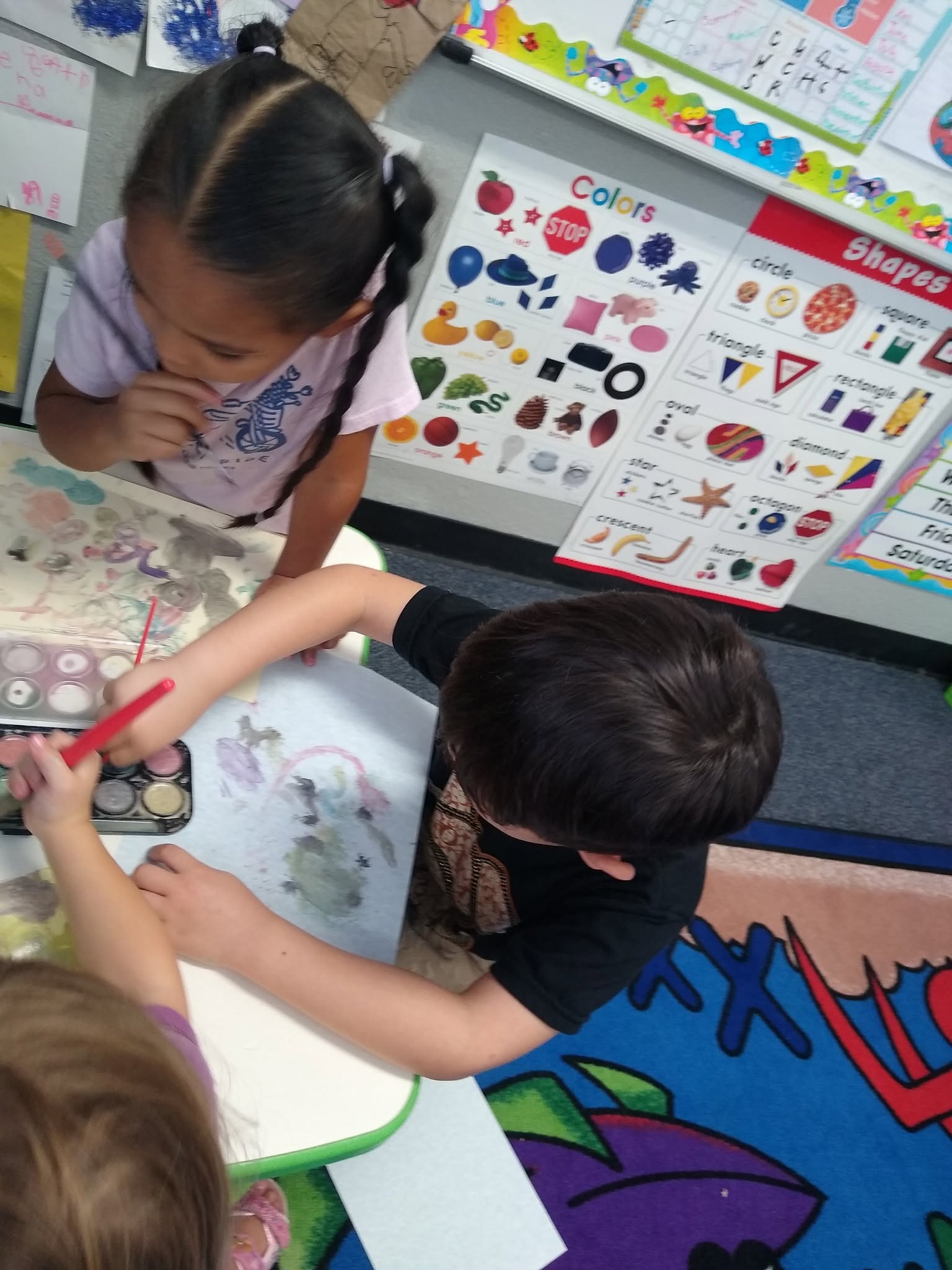 Students drawing at a table