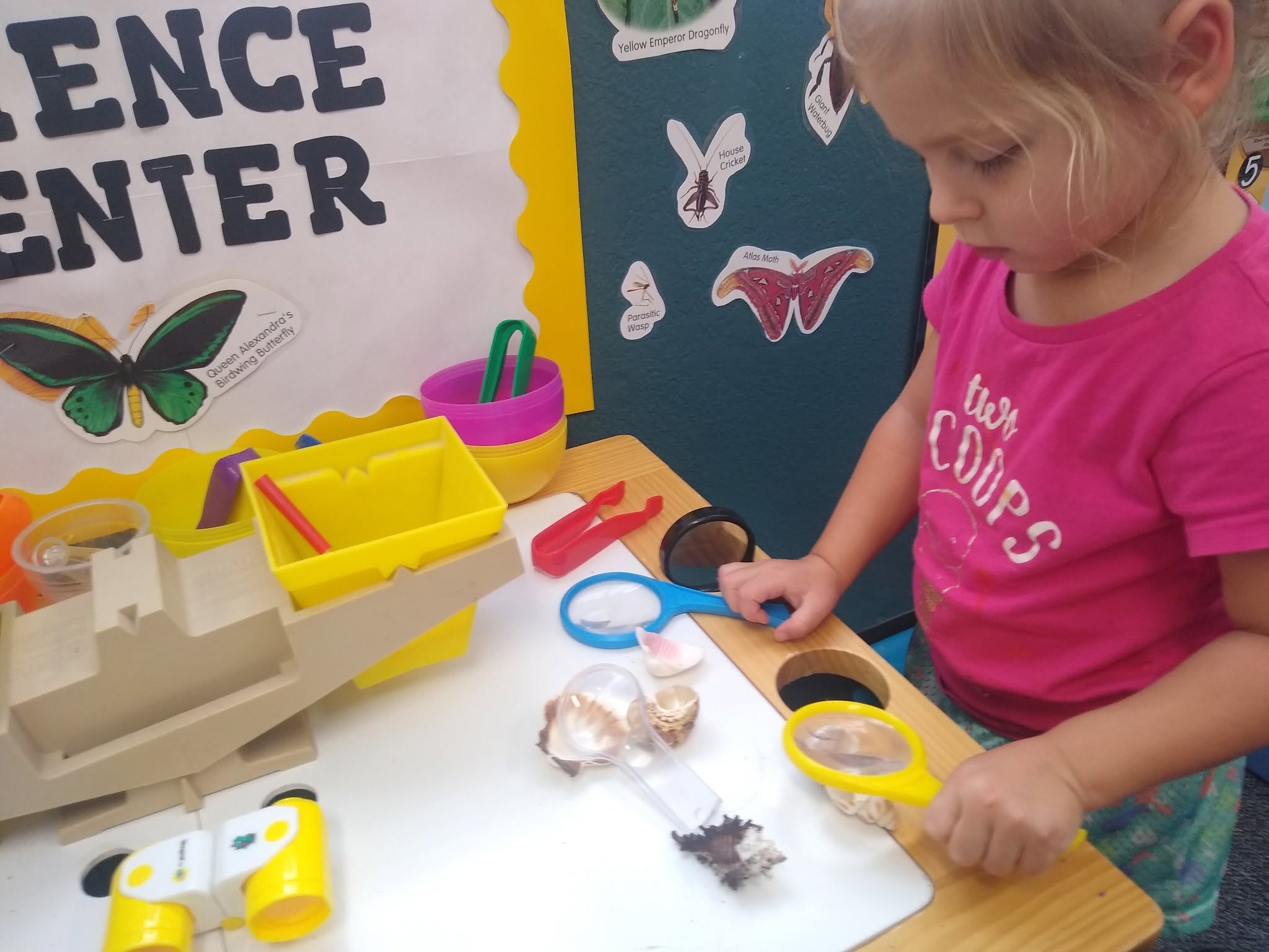 A student exploring with magnifying glasses